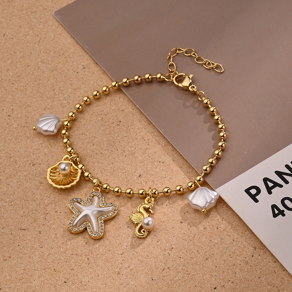 Set Collar y Pulsera con Dijes Marinos Dorados