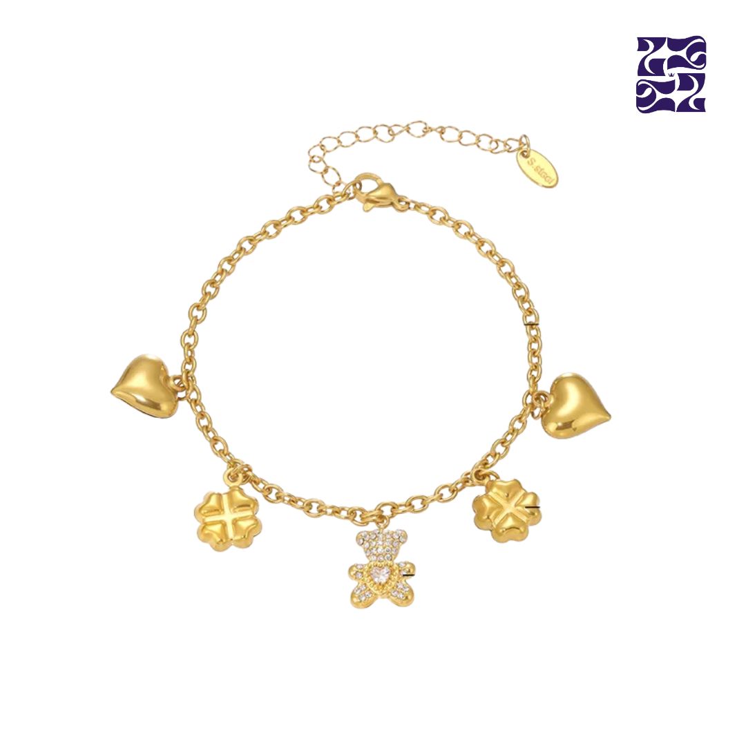 Pulsera con Dijes de Osito, Corazón y Trébol – Oro y Plata